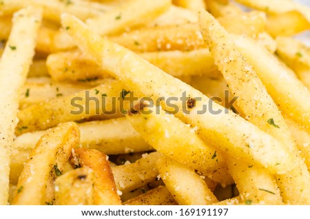 French fried in black dish on white background