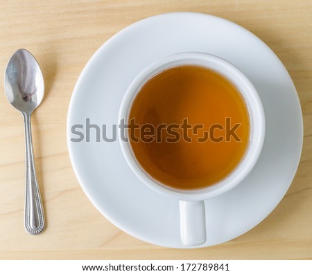 white tea cup&spoon on the wood table (Bird eye view)