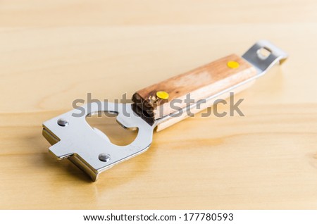 Can opener on wood background