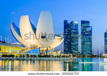 SINGAPORE, SINGAPORE - JUNE 25: The skyline of Singapore lit up at night with the ArtScience Museum in the foreground. Photo taken June 25, 2014 in Singapore, Singapore.