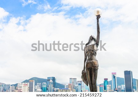 HONG KONG, CHINA - August 14: Statue and skyline in Avenue of Stars on August 14, 2014 in Hong Kong, China. The promenade honours celebrities of the Hong Kong film industry as the famous attraction.