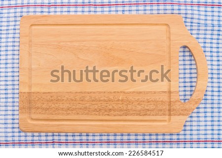 wood cutting board on tablecloth