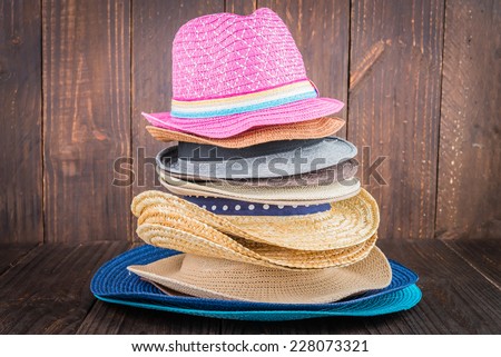 Beach hat on wooden background - vintage dark style pictures