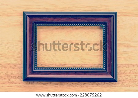 Vintage frame on wooden background process vintage style picture