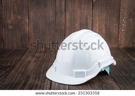 Construction hard hat on wooden background