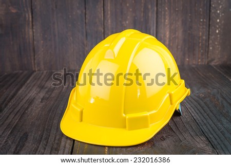 Construction hard hat on wooden background