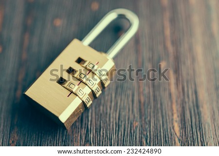 Close up pad lock on wooden background - vintage effect style pictures