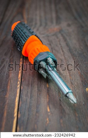 Screw driver on wooden background - vintage effect style pictures