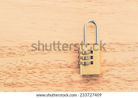 Key pad lock on wooden background process vintage style picture