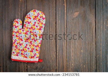 Kitchen glove on wooden background - dark effect style pictures