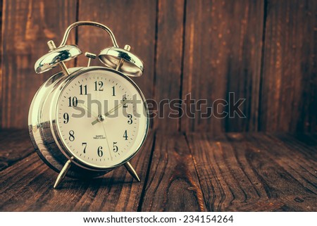 Clock on wood background - vintage effect style pictures