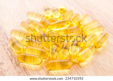 fish oil capsule on wooden background