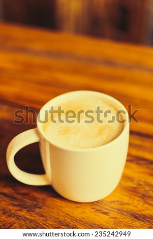 Latte coffee cup on table in coffee shop - Vintage old effect processing picture style
