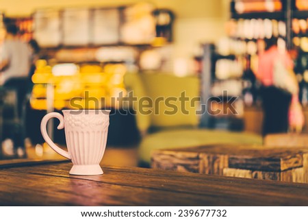 Coffee mug on wooden table in coffee shop - Vintage effect style pictures processing