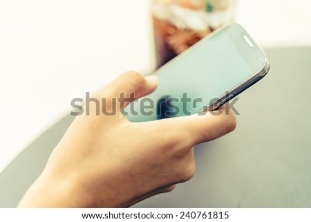 Hand holding mobile phone - Vintage effect style pictures