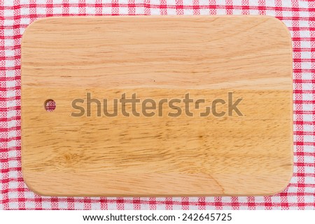 wood cutting board on tablecloth