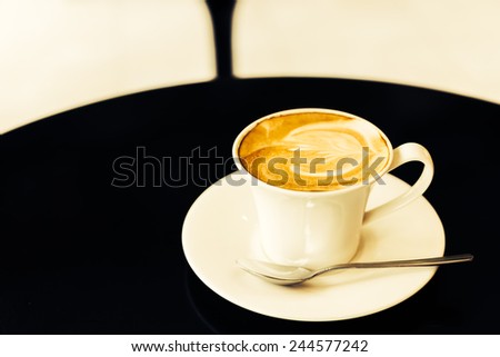 Latte coffee cup on table in coffee shop - Vintage old effect processing picture style