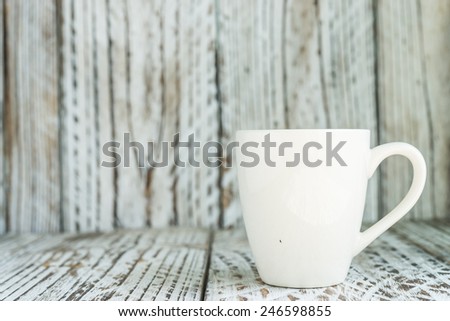 White coffee mug on wood background