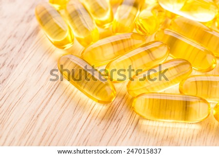 fish oil capsule on wooden background