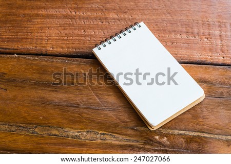Note book paper on wooden background - Vintage effect style pictures