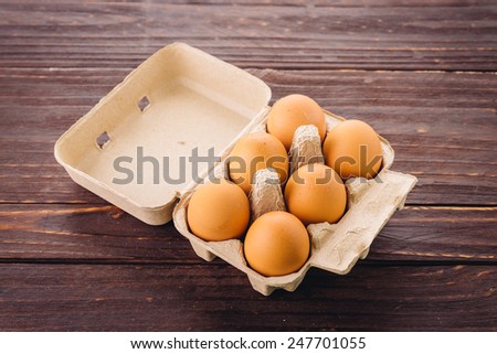 eggs pack on wood background