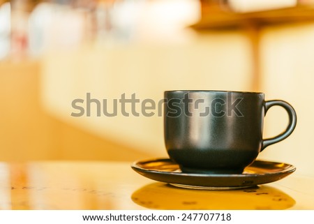 Black Coffee mug on wooden table in coffee shop - Vintage retro effect style pictures