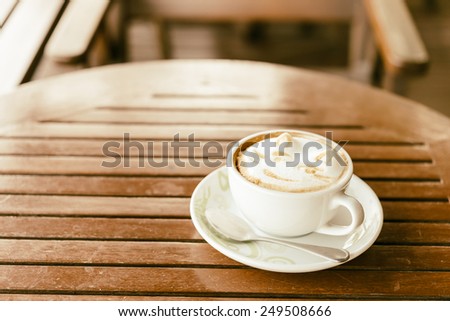 Latte coffee mug on wooden table - vintage effect style pictures