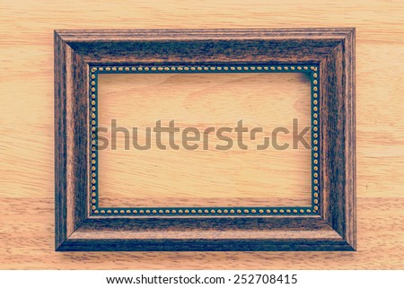 Vintage frame on wooden background process vintage style picture