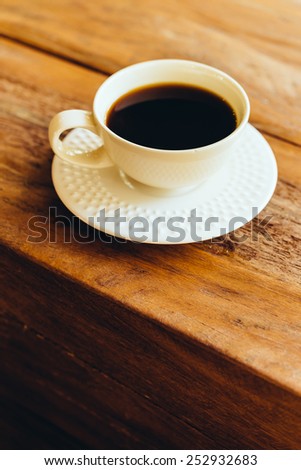 Coffee cup on wooden table - Vintage effect