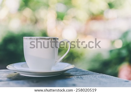 Coffee mug on wooden table outdoor background - Vintage effect style pictures