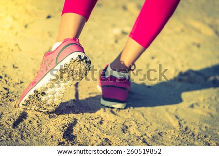 Selective Running shoes on the beach - vintage effect and sun flare filter process