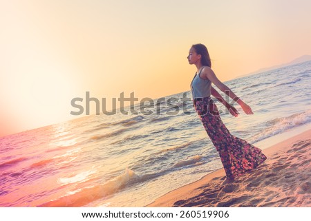 Happiness Young woman on the beach at sunset times - vintage effect and light leak filter processing style pictures