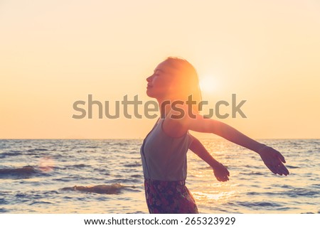 Happiness Young woman on the beach at sunset times - vintage effect and light leak filter processing style pictures
