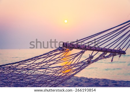 Hammock sunset on the beach - vintage filter
