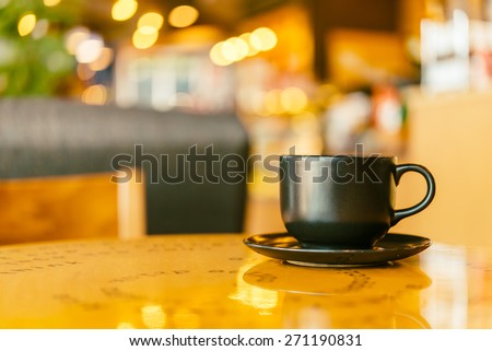 Black Coffee mug on wooden table in coffee shop - Vintage retro effect style pictures
