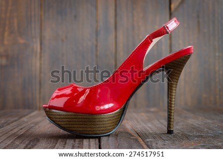 Red high heel on wooden background - vintage effect style pictures