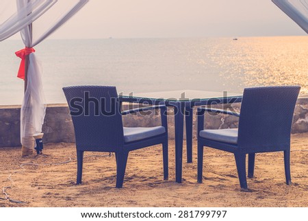 Table dinner on the beach on twilight time - vintage filter