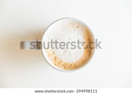 Top of view coffee cup on white table with hard light from side window