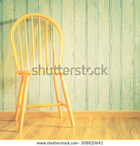 Vintage wood chair on wood background with copy space - vintage filter effect