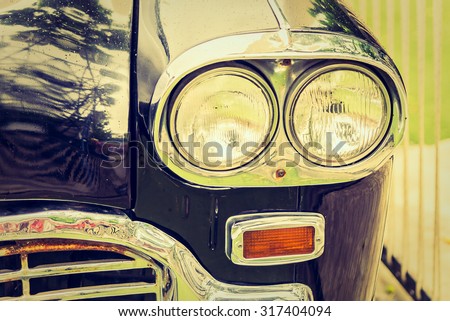 Vintage headlight lamp on vintage classic car - vintage filter effect