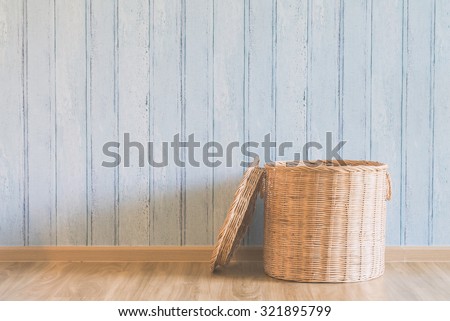 Wicker basket in the empty room - light vintage filter effect