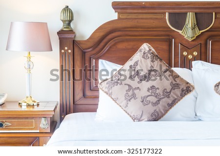 Pillow on bed with light lamp decoration in bedroom interior