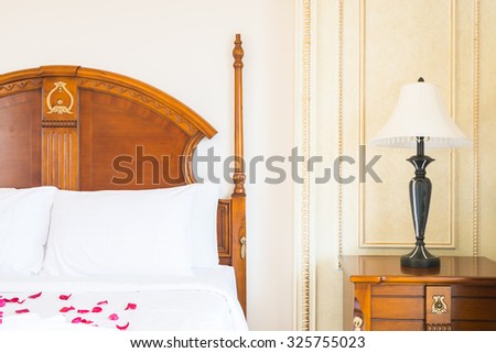 White Pillow on bed and light lamp decoration in hotel bedroom interior