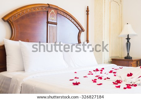 White Pillow on bed and light lamp decoration in hotel bedroom interior
