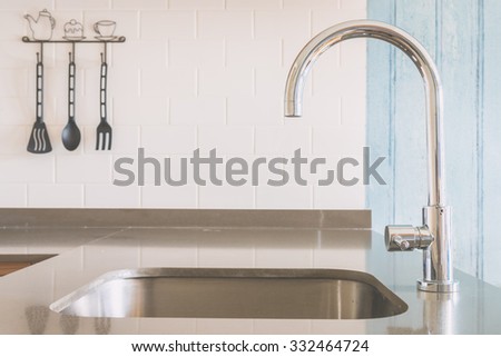 Faucet sink at kitchen - vintage light tone filter