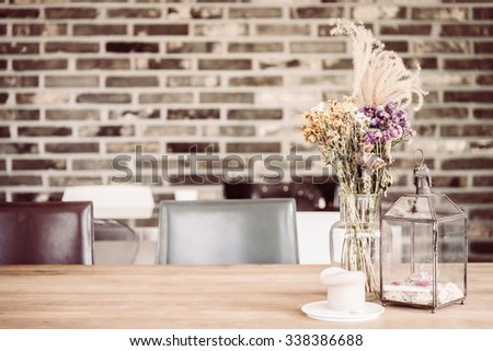 Dry flower in vase and candle decoration in coffee shop cafe - vintage filter effect