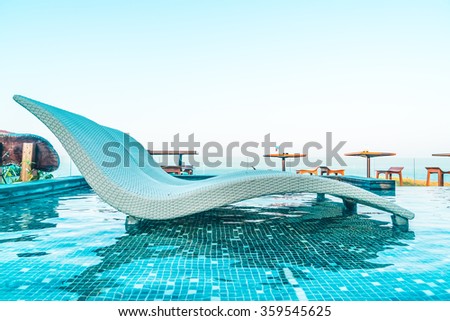 Umbrella and chair pool around beautiful luxury hotel swimming pool - Vintage Filter