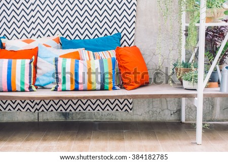 Patio outdoor deck with colorful pillow on chair decoration exterior of home - Vintage light filter
