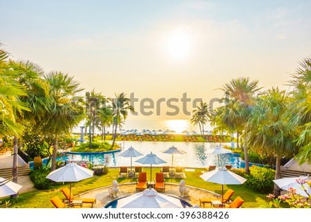 Empty Umbrella and chair around swimming pool in hotel resort