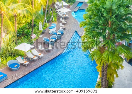 Aerial view of Beautiful luxury hotel swimming pool resort with umbrella and chair - Boost up color processing